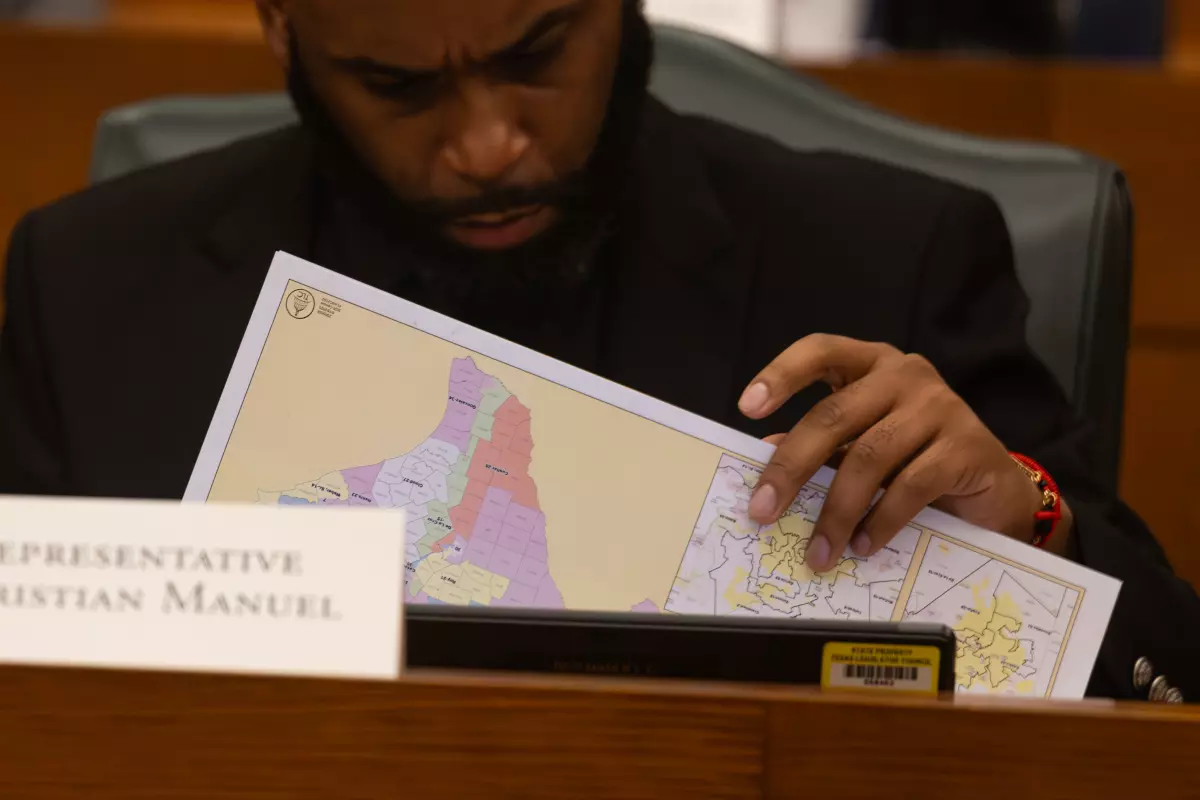 Rep. Christian Manuel looks over the US Congressional Map during the Congressional Redistricting committee meeting  at the Texas Capitol on Thursday, July 24, 2025. Patricia Lim/KUT News