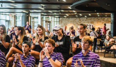 Jennifer Jackson holding Big 12 Tournament Most Outstanding Player Trophy