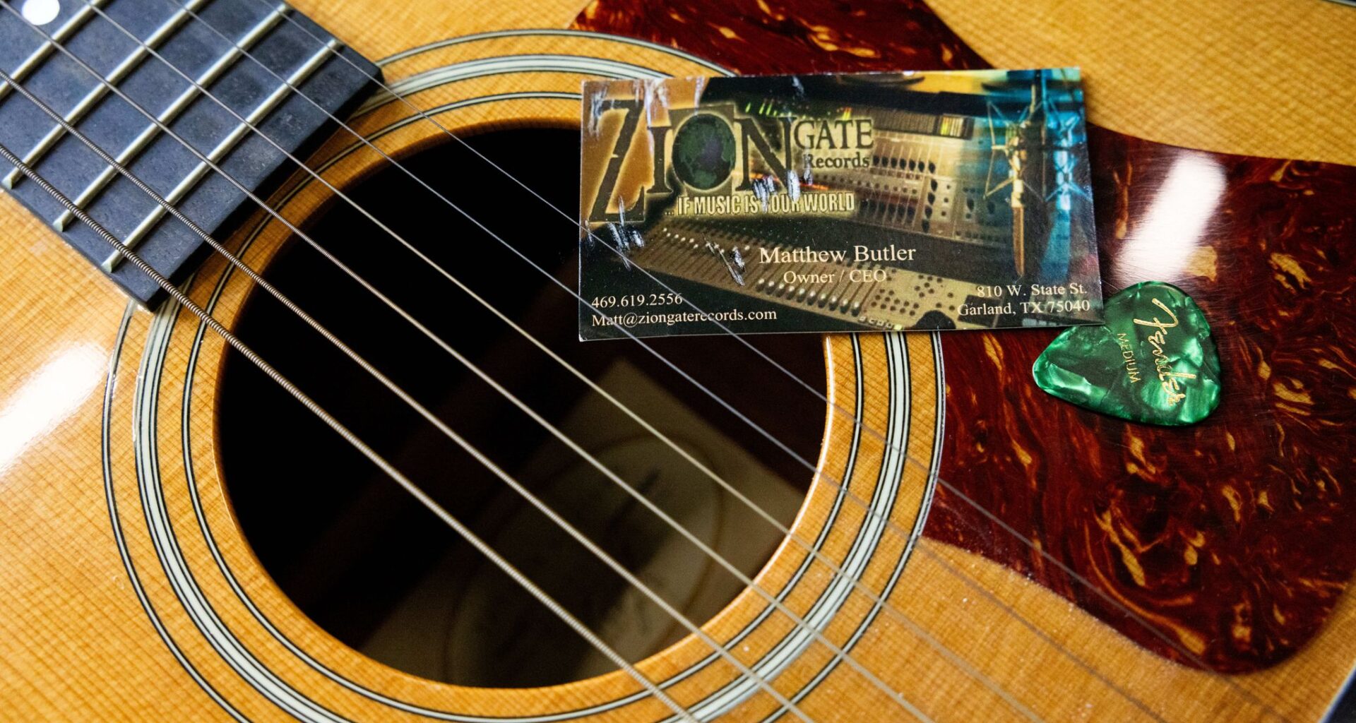 A photo of Matthew Butler with his son, Matthew Butler Jr., is photographed next to his jacket and guitar in Dallas, Monday, April 27, 2026. Butler and Stephen Swan were killed outside of the Zion Gate Records in Garland on June 19, 2008.