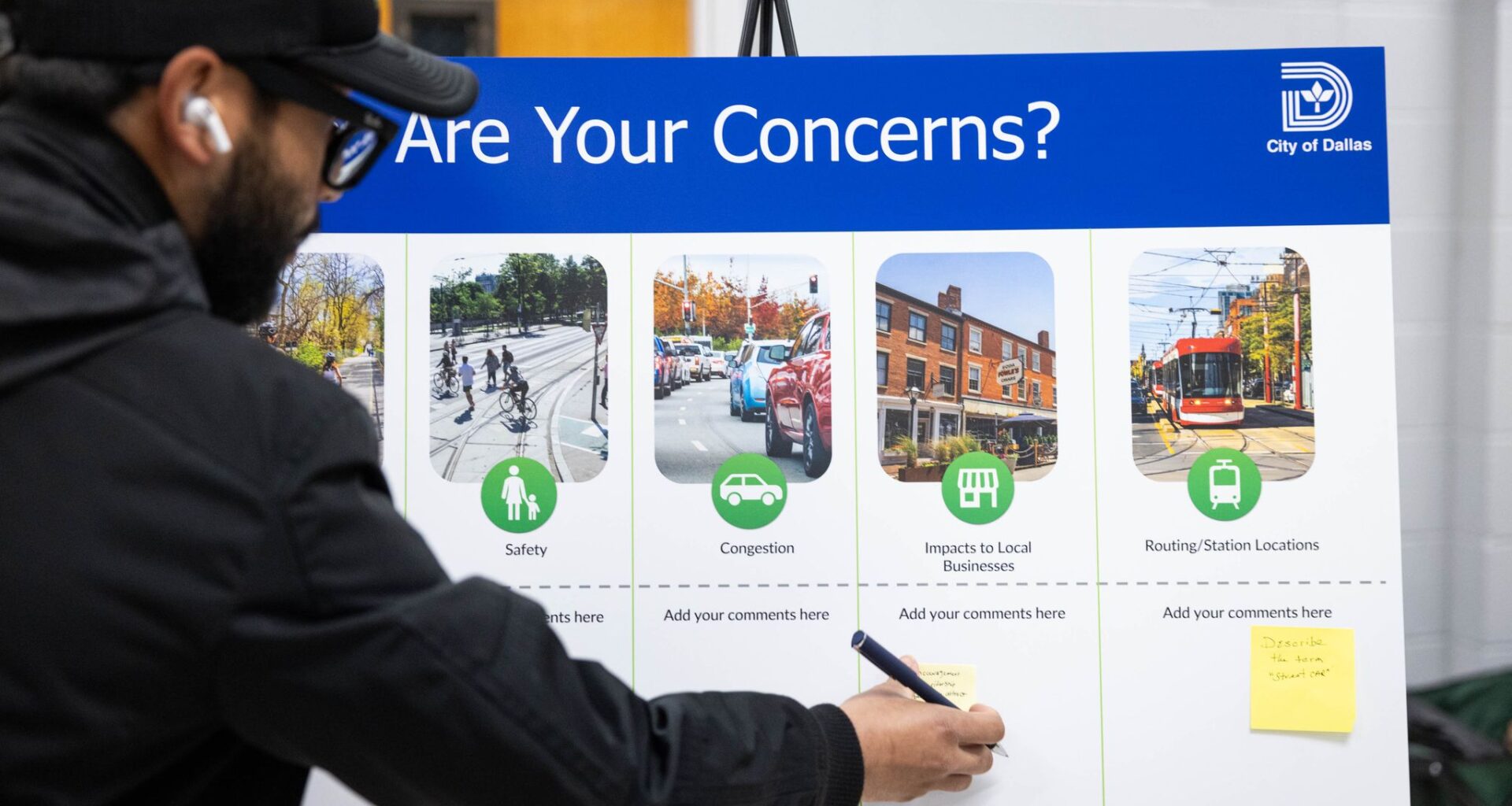 Edwin Juarez of Old East Dallas writes a concern about attracting riders to local businesses at an event to collect feedback on a proposed streetcar in South Dallas, Tuesday, April 21, 2026.