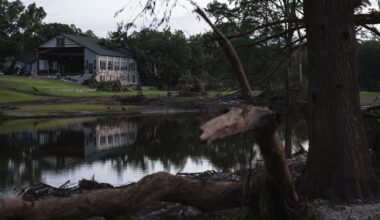 FILE - A building at Camp Mystic is reflected in water after a flash flood swept through the area, on July 7, 2025, in Hunt, Texas. (AP Photo/Eli Hartman, File)