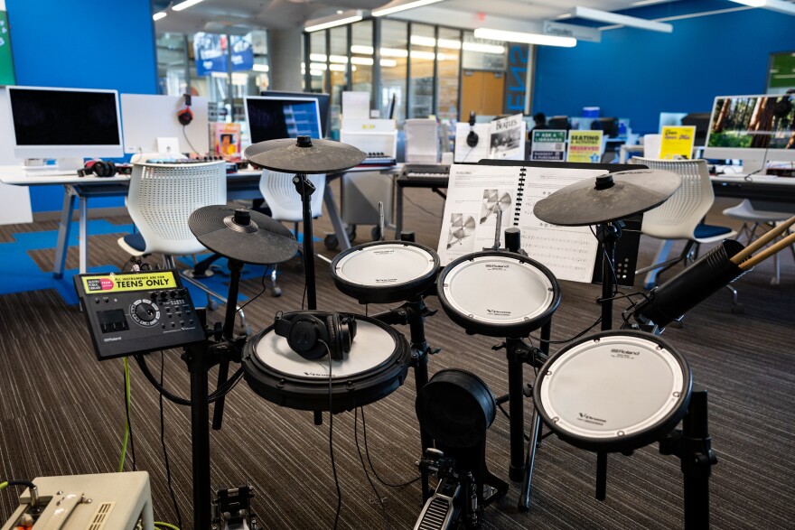 An electronic drum kit sits inside a room at the library.