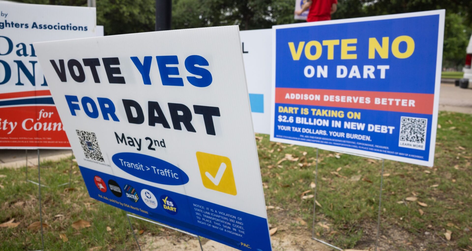 Political signs, including signs for and against the  Dallas Area Rapid Transit, on display during the last day of early voting at Addison Town Hall in Addison, TX, Tuesday, April 28, 2026. Addison voters will decide whether DART service continues in the city or if trains and buses will move through without stopping.