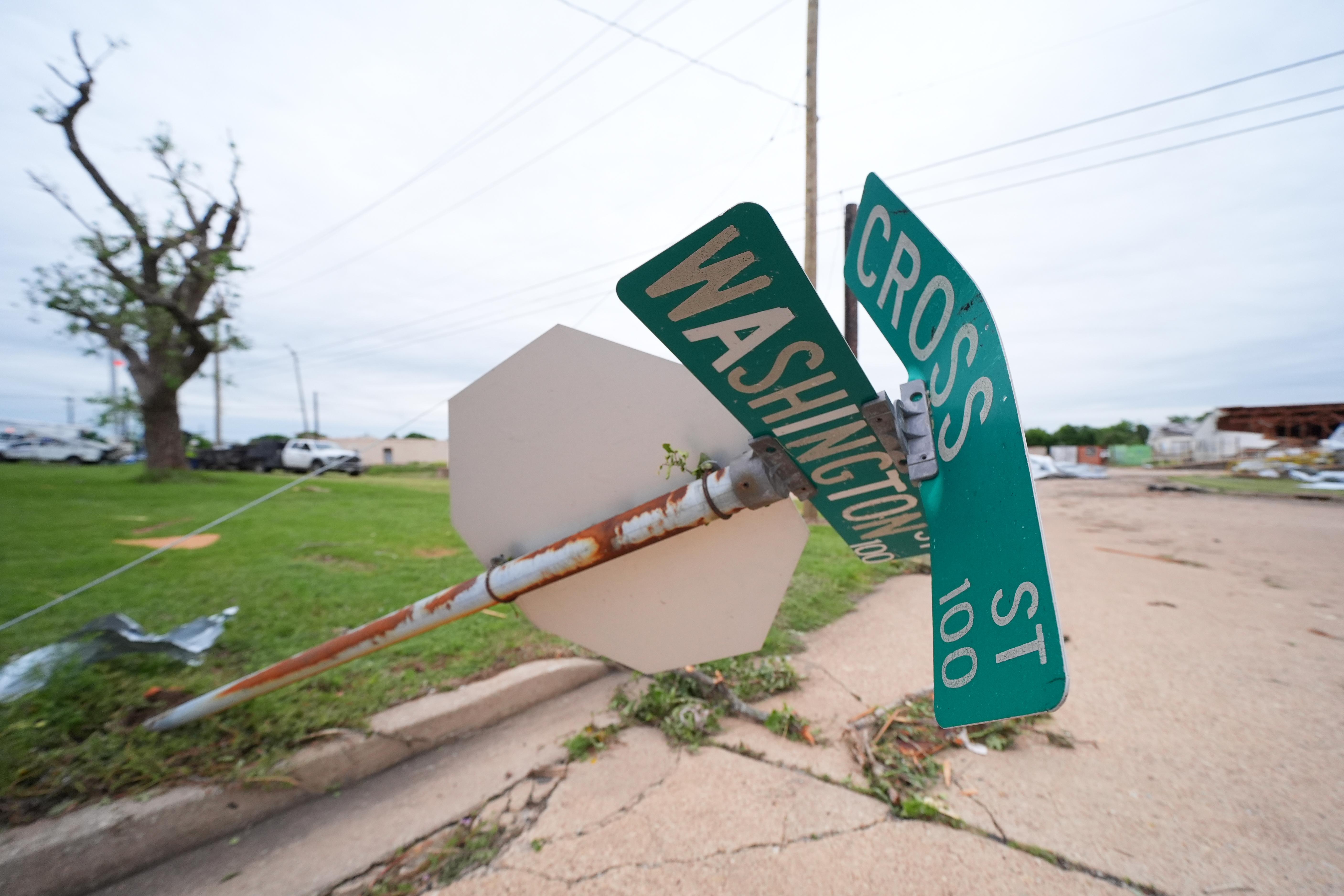 A downed street sign is visible following a storm in...