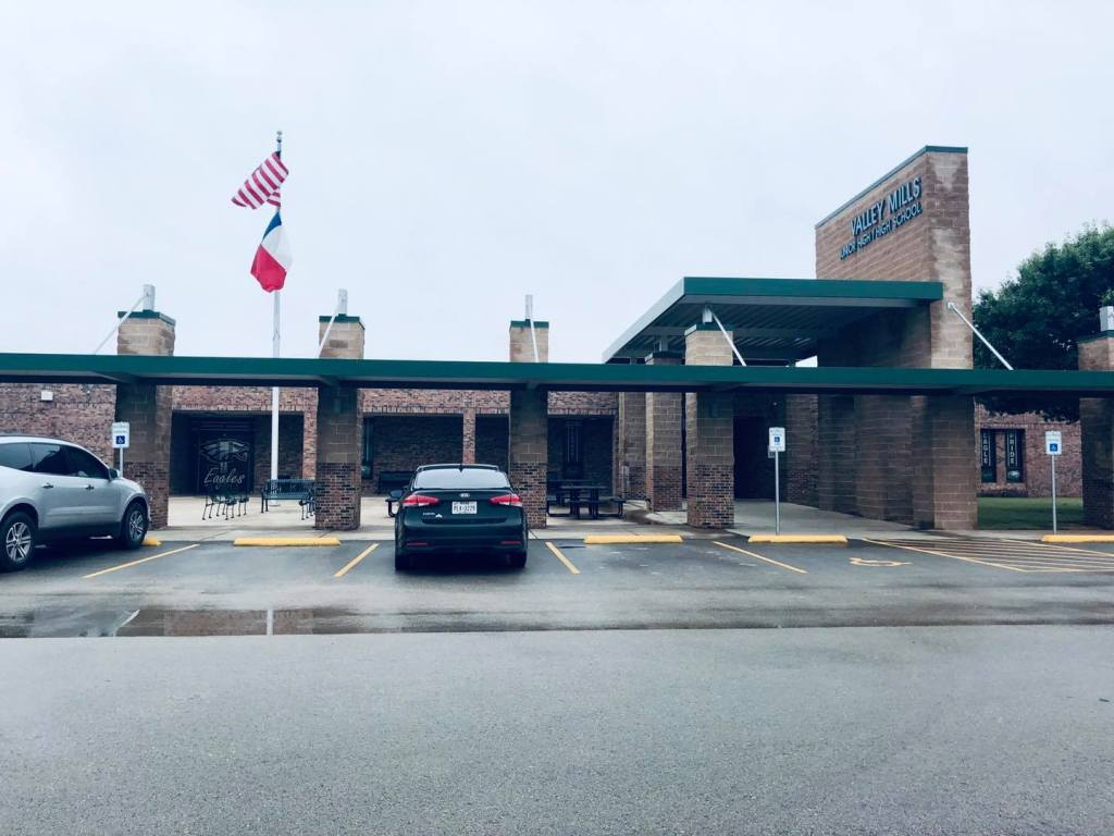 Valley Mills Junior High School building exterior with an American flag flying.