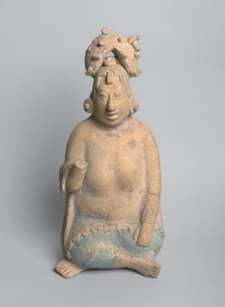 A photograph of a small earthenware female figure.
