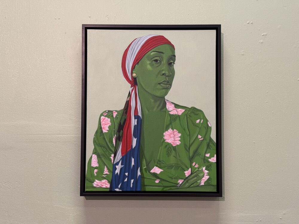 A portrait of a green woman wearing an American flag headscarf