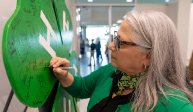 A woman signs a Texas 4-H placard.