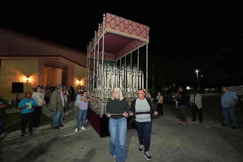 Corpus Christi Catholic Church members push a large float that will carry the Lady of Hope Macarena during a rehearsal for their Good Friday procession, Monday, March 23, 2026, in Miami, Fla. (AP Photo/Marta Lavandier)
