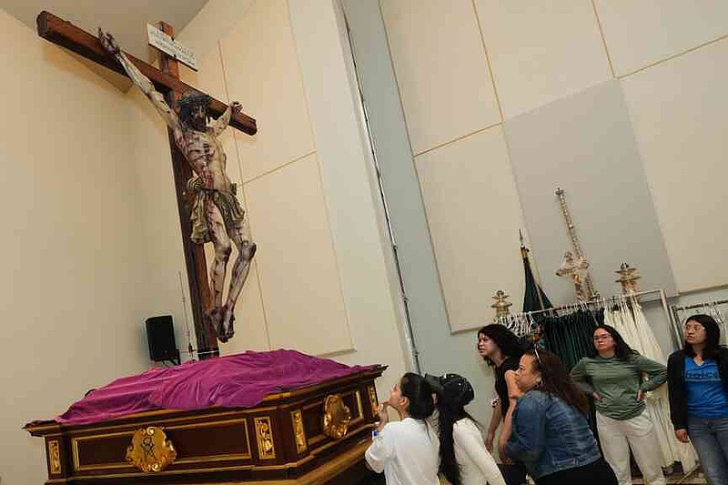Corpus Christi Catholic Church youth members look up at a statue of Jesus crucified during a rehearsal for their Good Friday procession, Monday, March 23, 2026, in Miami, Fla. (AP Photo/Marta Lavandier)