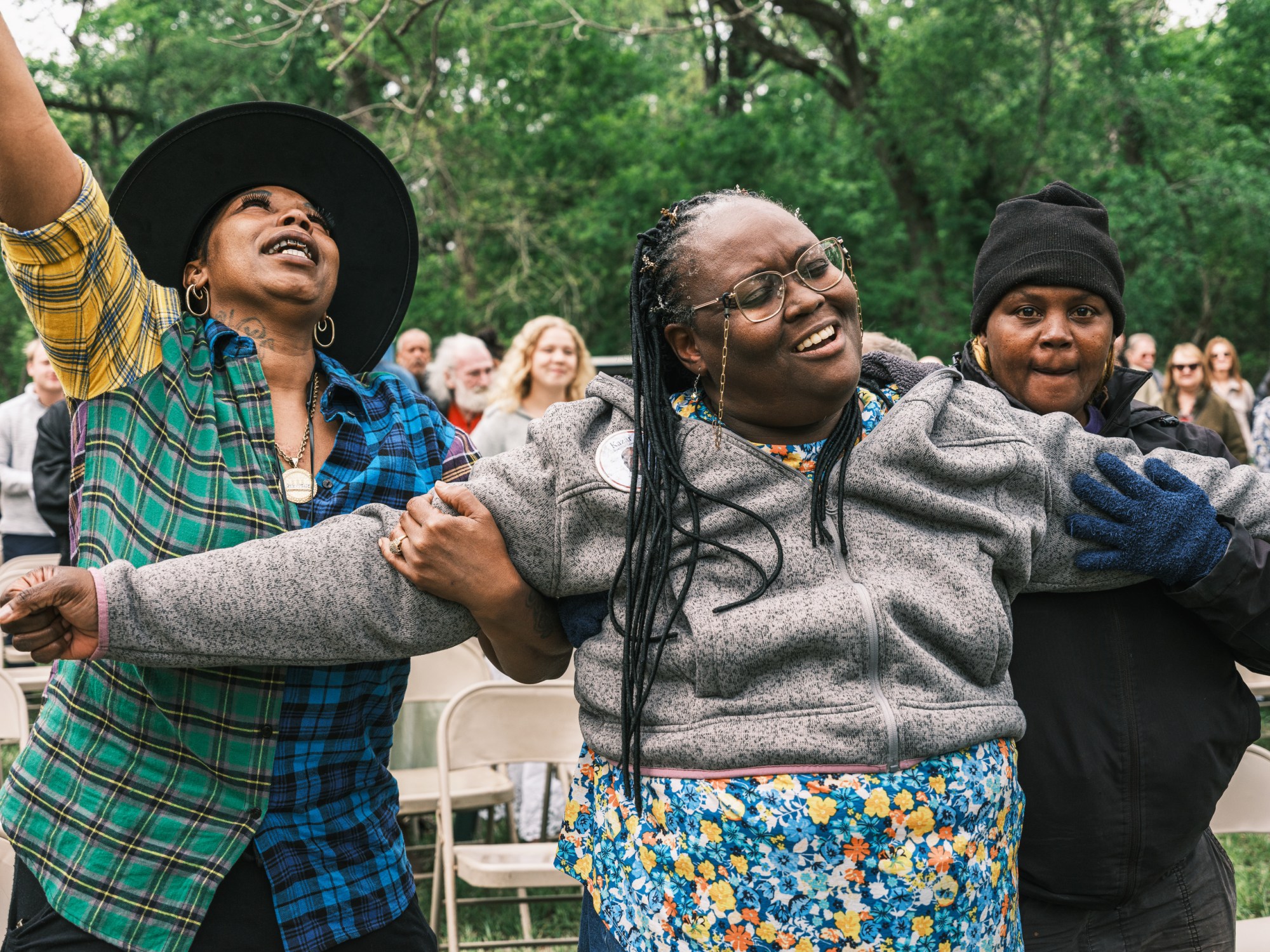 Longtime friends of Jimmy Dorrell sing along during Church Under the Bridge’s annual Easter service along the Middle Bosque River west of Waco on Easter Sunday.