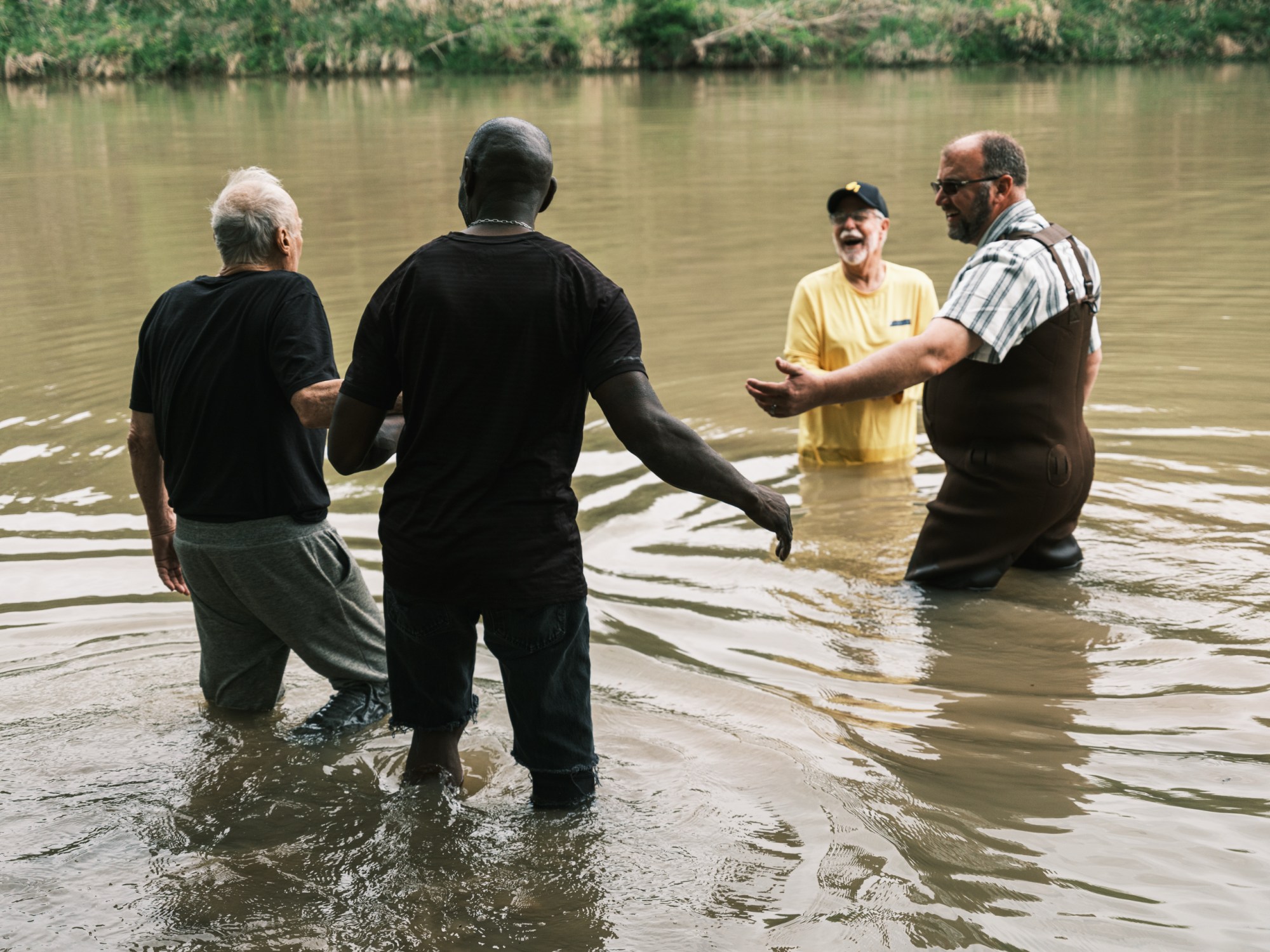 John Dokken is guided out into the Middle Bosque River to be baptized by Jimmy Dorrell and Kevin Brown during the Easter service.