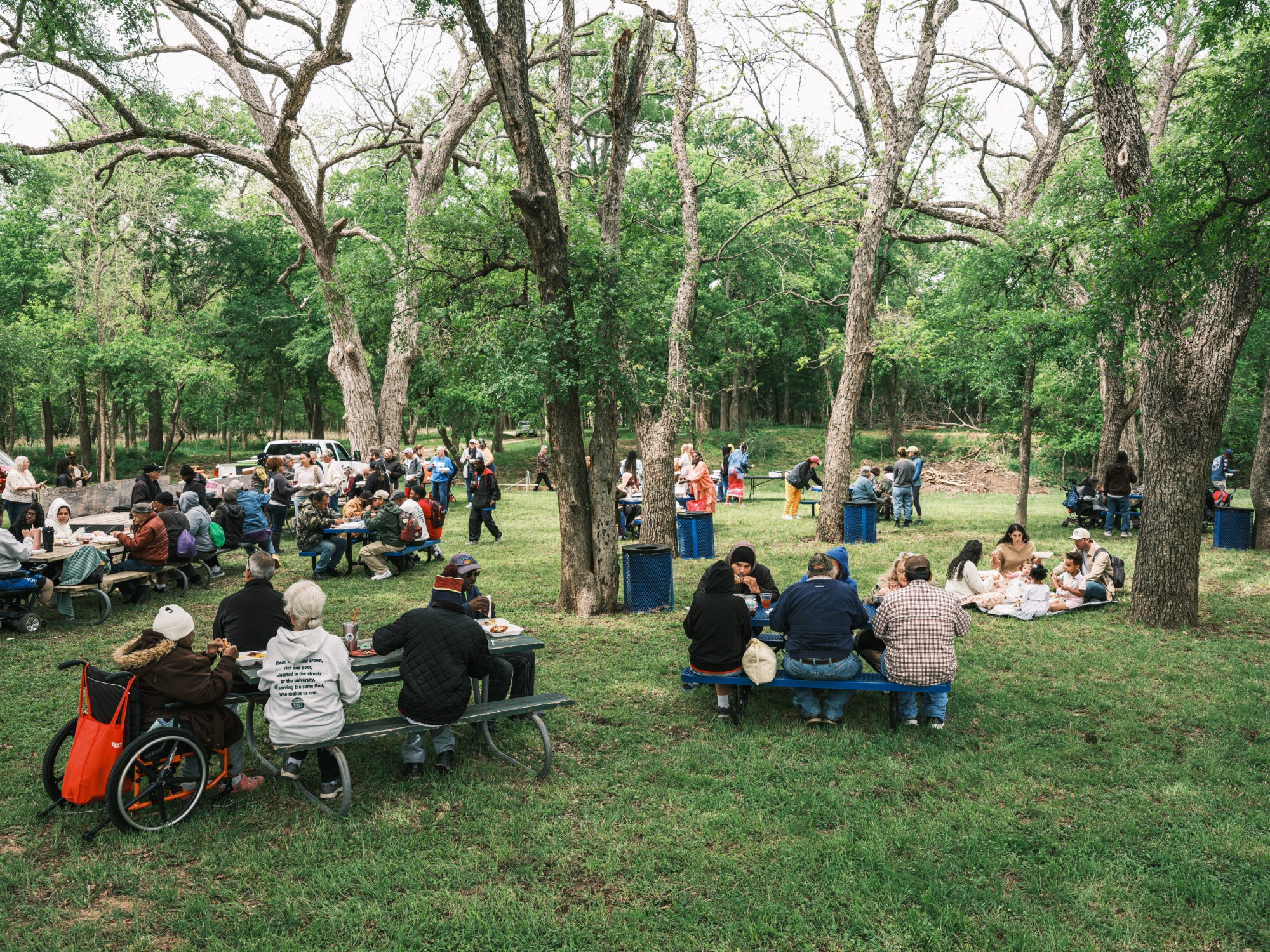 Congregants eat lunch after Church Under the Bridge’s Easter service along the Middle Bosque River west of Waco on Sunday.
