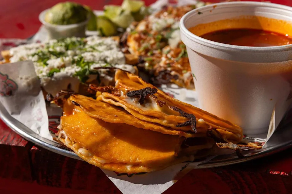 Quesatacos and consomé are plated for the sampler platter at Birrieria y Taqueria Cortez in Fort Worth on Wednesday, Nov. 20, 2024. 