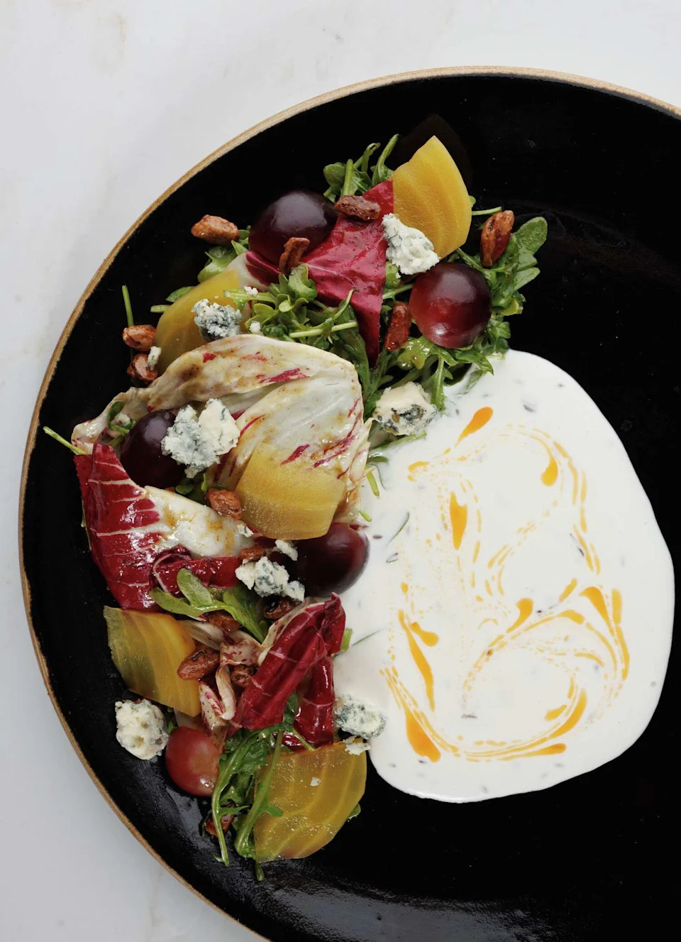 Salads are artful at Top Brass, the American bistro inside Hotel Dax in Addison. Here's the chicory and greens salad. (Nathan Hunsinger/The Dallas Morning News)