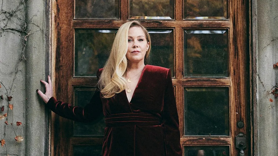 Christina Applegate poses wearing a red velvet dress
