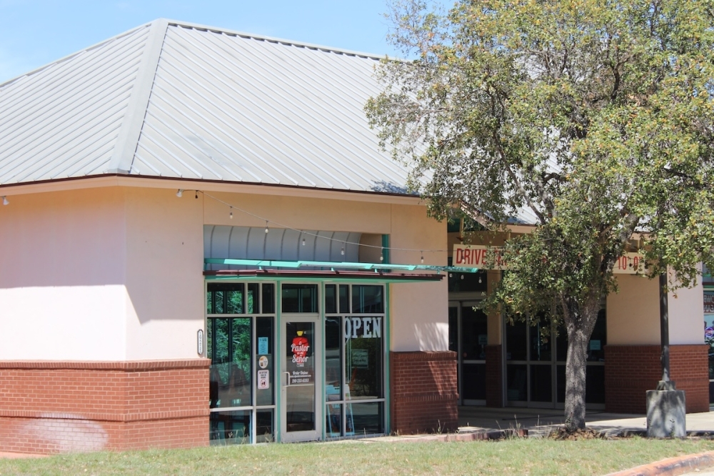 The exterior of a taco restaurant on a sunny day.