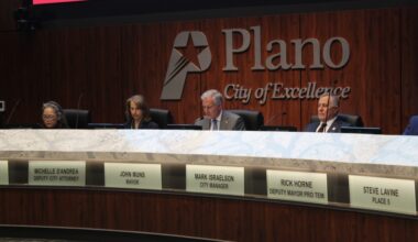 Mayor Pro Tem Maria Tu, Deputy City Attorney Michelle D'Andrea, Mayor John Muns, and City Manager Mark Israelson sit behind the dais in the Plano City Council chambers.