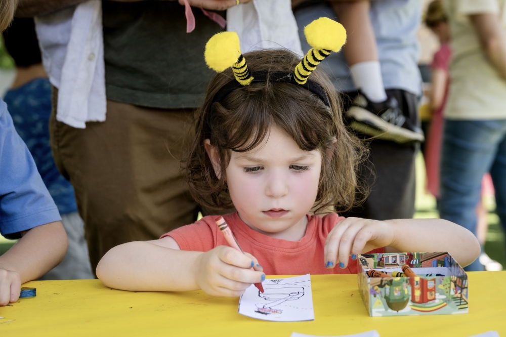 A young attendee colors at the Books and Bees Festival at Bee Cave Public Library, where literacy programming meets live bee education. (Courtesy Bee Cave Public Library)