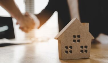 Individuals shake hands on the closing of a home sale