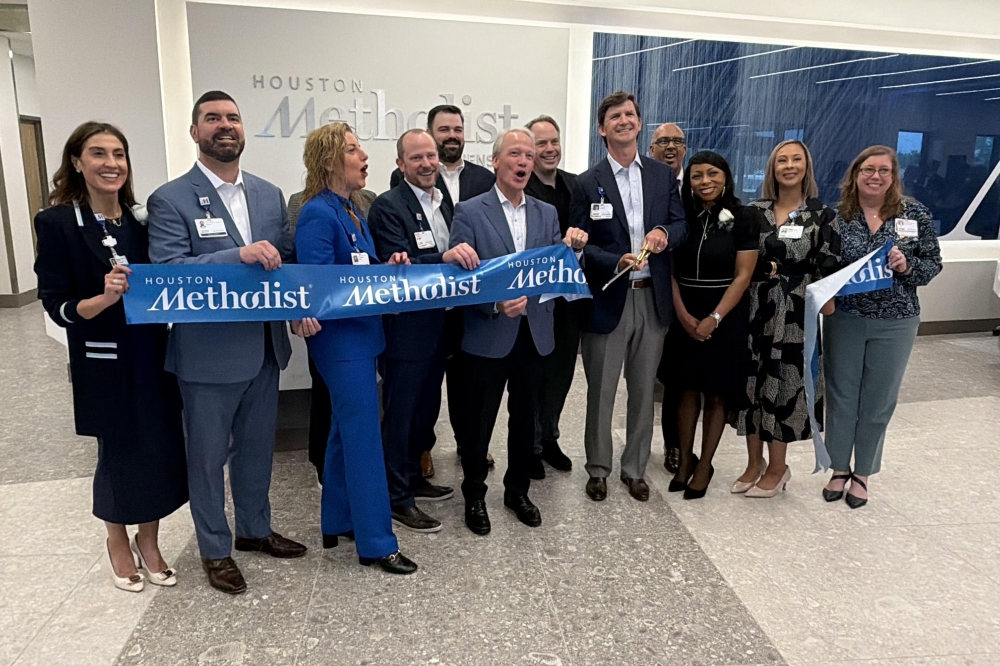 Houston Methodist employees gather to cut the ribbon at the new comprehensive care center in Cinco Ranch. (Bradley Dountz/Community Impact)