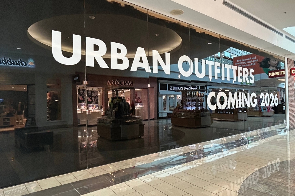 Exterior of a storefront in a mall featuring Urban Outfitters Coming 2026 temporary signage in the windows.