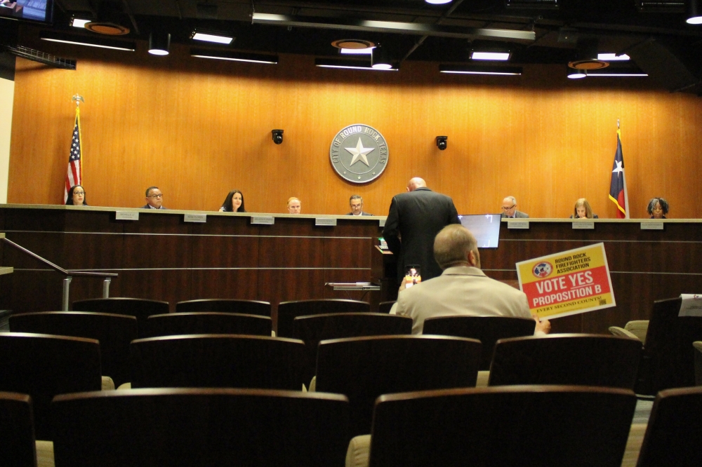Billy Colburn, former president of RRPFA, delivers comments regarding the history of the Round Rock Fire Department at an April 9 council meeting, with Bill Clifton, secretary of the firefighters association, in the audience. (Brooke Sjoberg/Community Impact)