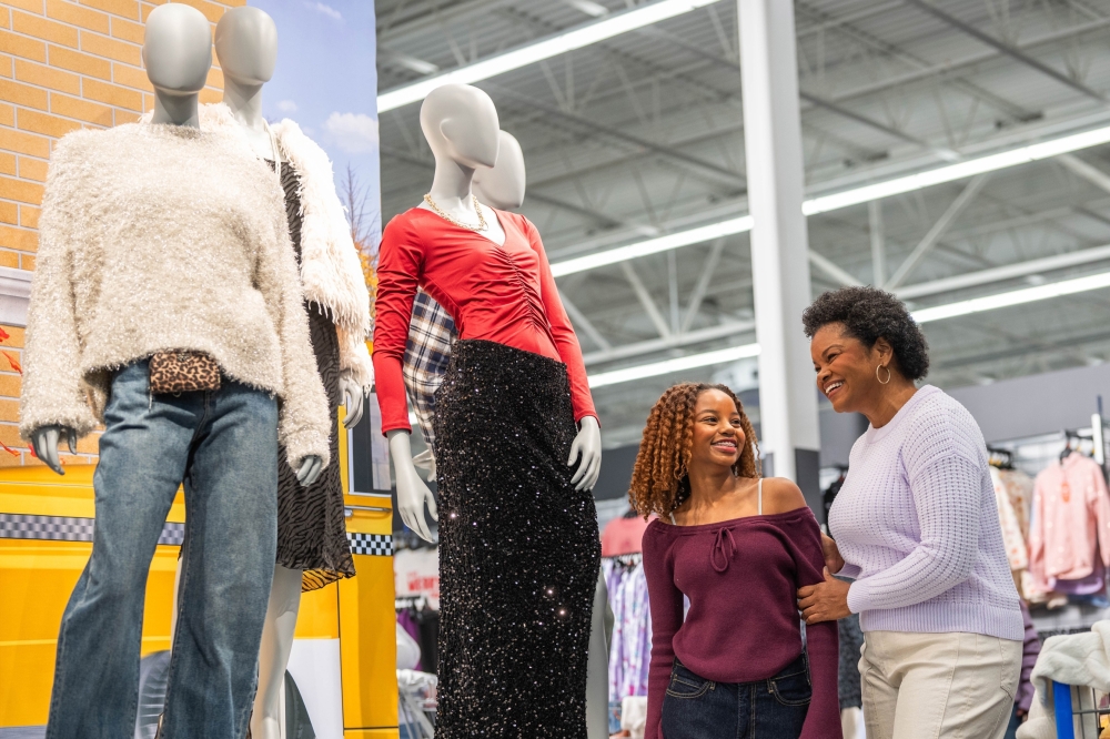 Mom and daughter shopping in Walmart with mannequin showcase