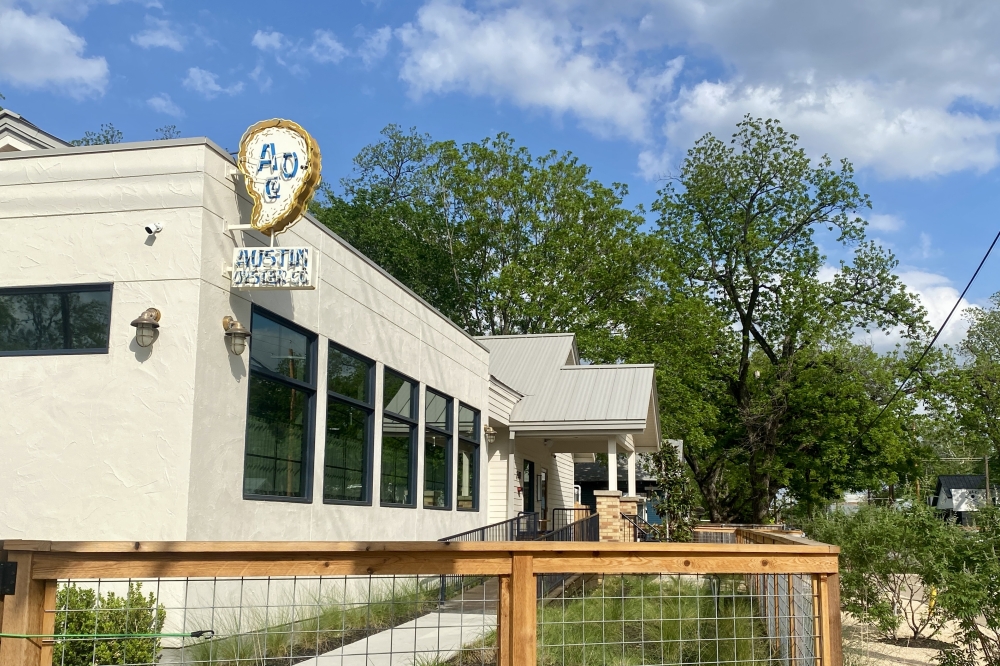 Austin Oyster Co. is now open in a reimagined 1950s craftsman home. The interior features a bar made from the original wood from the home and hand painted tiles. (Katlynn Fox/Community Impact)