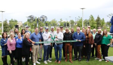 Greg Bartoli, founder and CEO of PopStroke, and Jim Penniman-Morin, mayor of Cedar Park, cut the ribbon on the mini golf venue's Cedar Park location April 20. (Daniel Schwalm/Community Impact)
