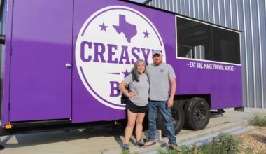 Erika and Ryan Chody stand with their custom-built food truck. They will launch the truck's operations in May. (Brooke Sjoberg/Community Impact)