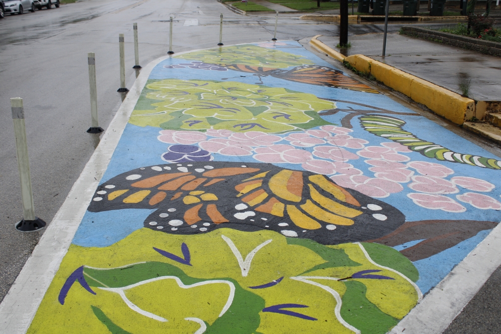 City staff began removing pavement artwork April 22 to comply with a Texas Department of Transportation directive. (Michael Milliorn/Community Impact)