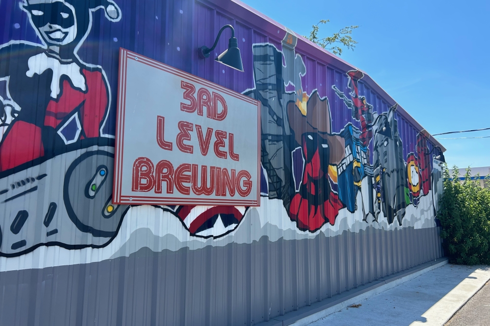 The exterior of 3rd Level Brewing includes a mural featuring comic book and video game characters. (Brooke Sjoberg/Community Impact)