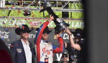 NASCAR Cup Series driver Joey Logano, center, holds up the trophy for winning the WÜRTH 400 last May in Fort Worth. (Cody Thorn/Community Impact)