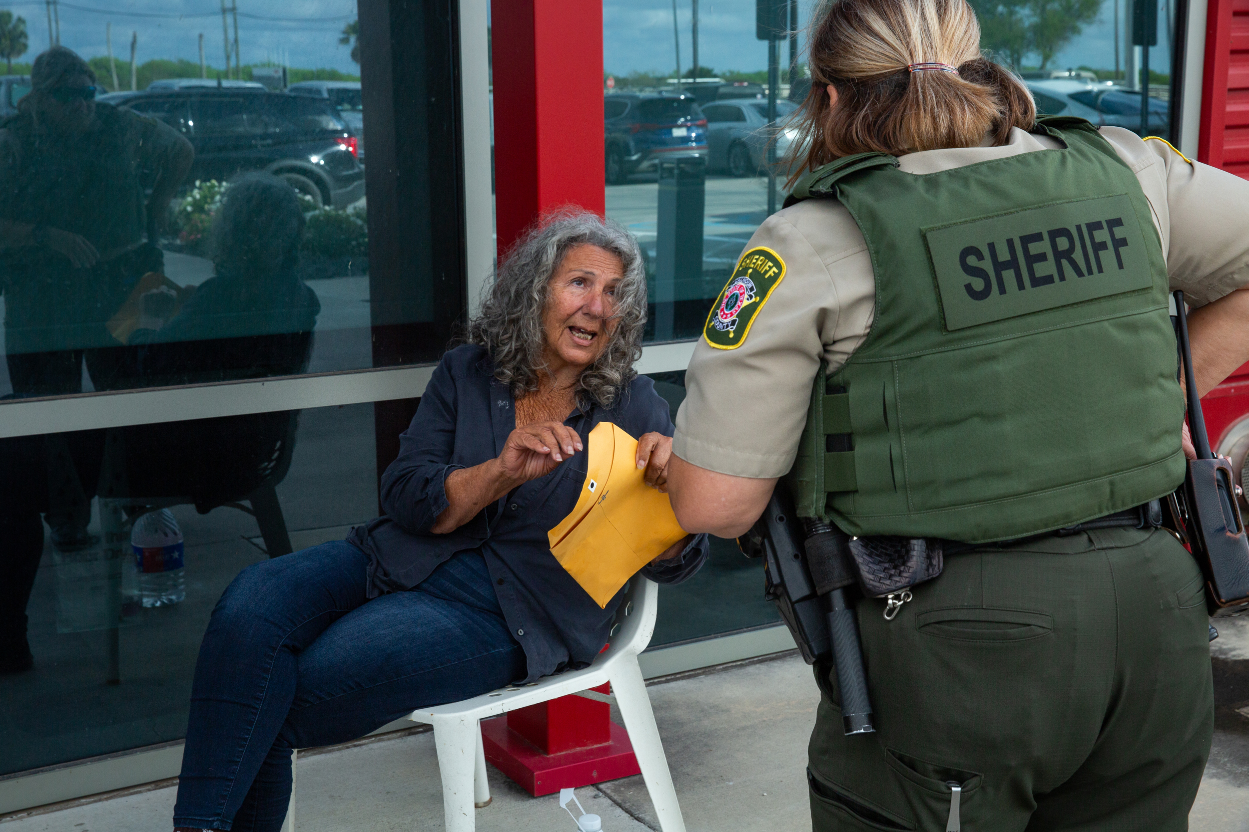 A Calhoun County Sheriff’s deputy confronts Diane Wilson at the Dow Seadrift offices, shortly before Wilson’s arrest on March 26.