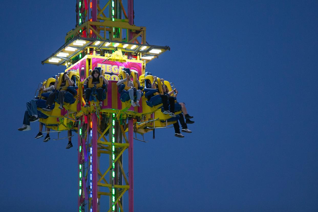 People ride the Mega Drop attraction at the annual Buc Days Carnival in downtown Corpus Christi on May 9, 2025.