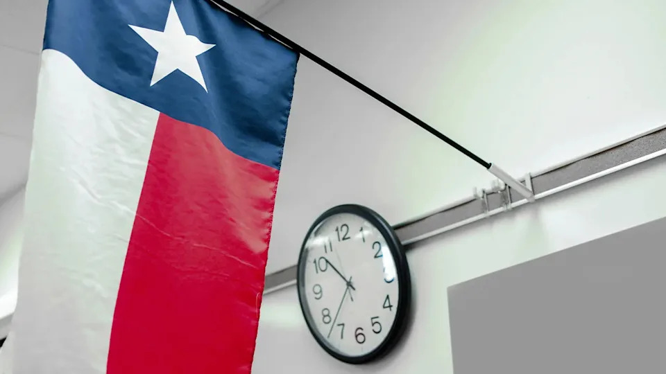 A Texas high school classroom with state flag and clock