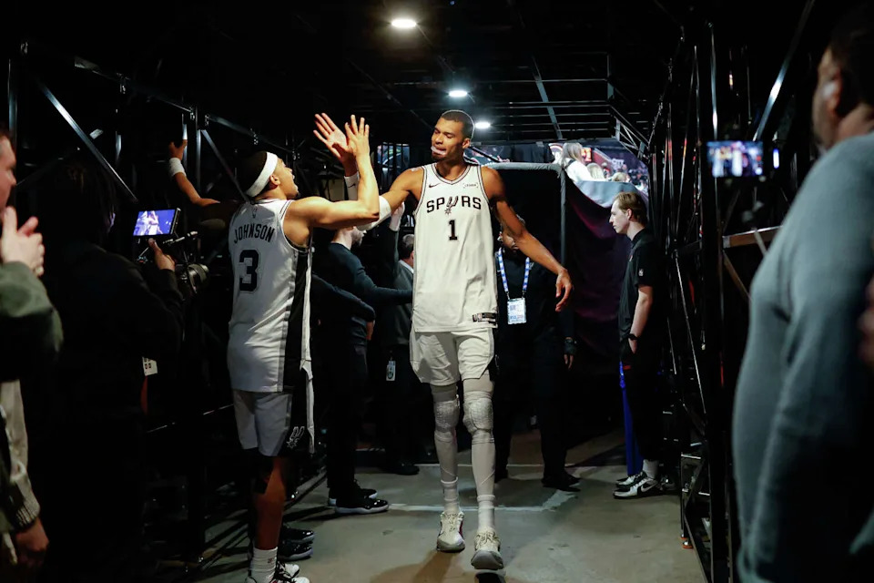 San Antonio Spurs forward Victor Wembanyama (1) slaps hands with San Antonio Spurs forward Keldon Johnson (3) as he walks back to the locker room following a post-game interview after Game 4 of a first-round NBA playoff series against the Portland Trail Blazers at Moda Center on Sunday, April 26, 2026. The Spurs won 114-93, leading the series 3-1. (Sam Owens/San Antonio Express-News)