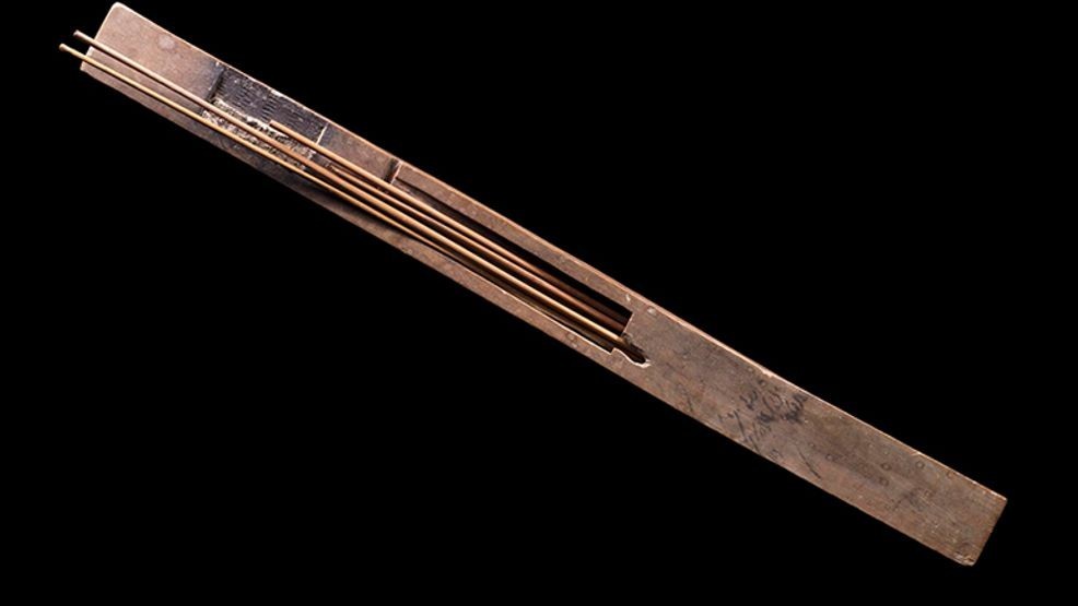 Writing palette and pen-case (Classmark 11500). Wooden palette and pen-case for a scribe, containing reed pens and a dried cake. 