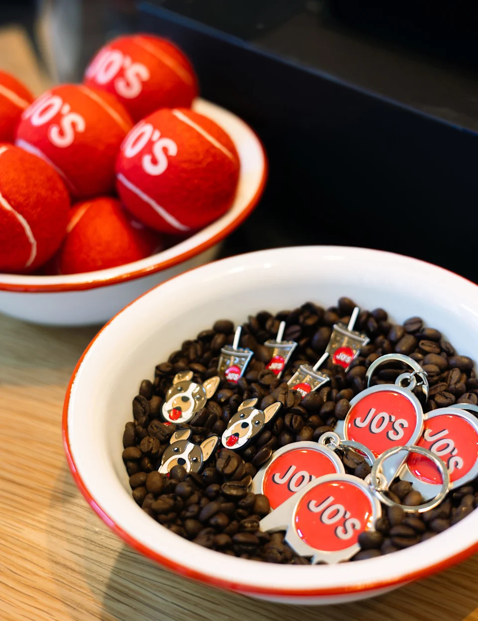 The flagship Austin location of Jo's Coffee features a red ball logo on top. Merchandise for sale in Nashville includes nods to it.