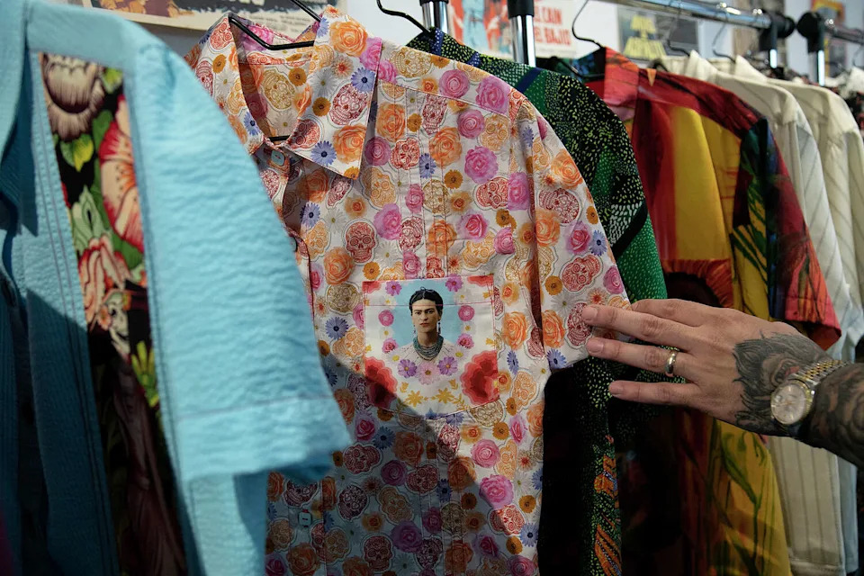 Javier Trevino, owner of Divide & Conquer Denim & Leather, shows details of his custom guayaberas at his store in downtown San Antonio in July 9 2021. (Lisa Krantz/San Antonio Express-News file photo)