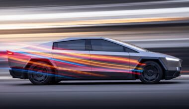 An abstract, colorful image with sweeping brushstrokes of vibrant hues, representing the dynamic motion and advanced engineering of a Tesla Cybercab autonomous vehicle.