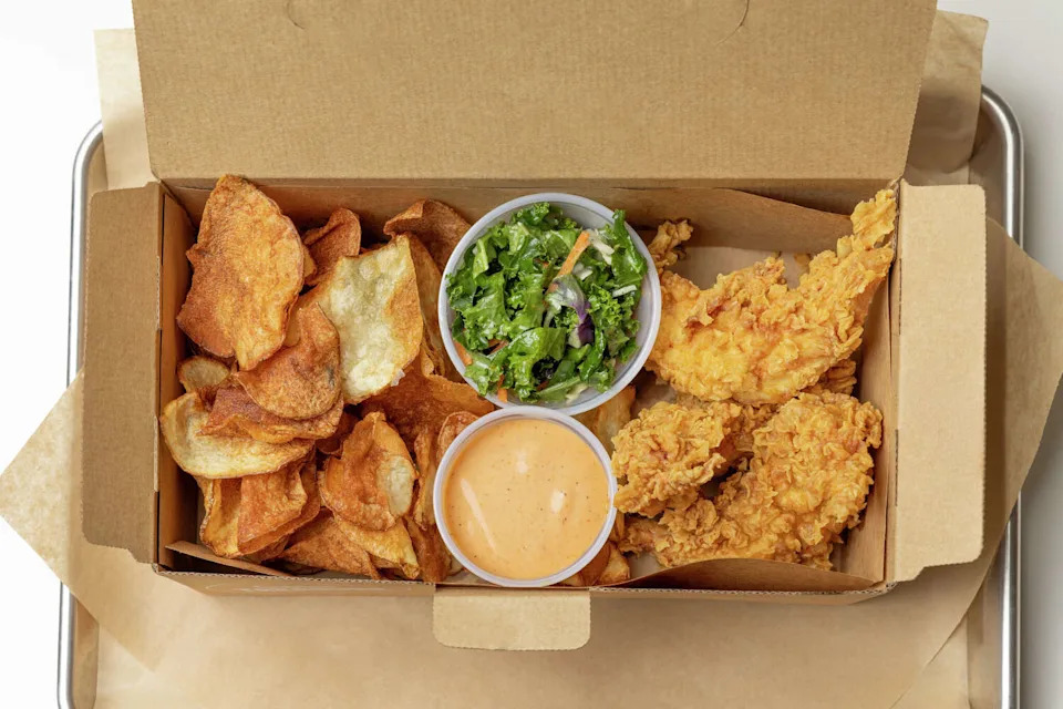 Chicken tenders at Flock and Fresh come with options of sides like kale salad and house-made chips. Kale? That's not common at competing quick-service chicken restaurants. (White Unicorn Agency)