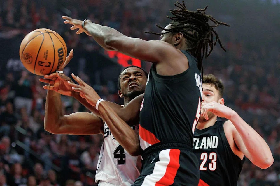 Portland Trail Blazers guard <a class="link " href="https://sports.yahoo.com/nba/players/4622/" data-i13n="sec:content-canvas;subsec:anchor_text;elm:context_link" data-ylk="slk:Jrue Holiday;sec:content-canvas;subsec:anchor_text;elm:context_link;itc:0" data-yga="{"yLinkElement":"context_link","yModuleName":"content-canvas","yLinkText":"Jrue Holiday","ySubModuleName":"anchor_text","yHasCommerce":false}">Jrue Holiday</a> (5) makes down a shot from San Antonio Spurs guard <a class="link " href="https://sports.yahoo.com/nba/players/5767/" data-i13n="sec:content-canvas;subsec:anchor_text;elm:context_link" data-ylk="slk:De'aaron Fox;sec:content-canvas;subsec:anchor_text;elm:context_link;itc:0" data-yga="{"yLinkElement":"context_link","yModuleName":"content-canvas","yLinkText":"De'aaron Fox","ySubModuleName":"anchor_text","yHasCommerce":false}">De'aaron Fox</a> (4) under the basket during the first quarter of Game 4 of a first-round NBA playoff series at Moda Center on Sunday, April 26, 2026. (Sam Owens/San Antonio Express-News)