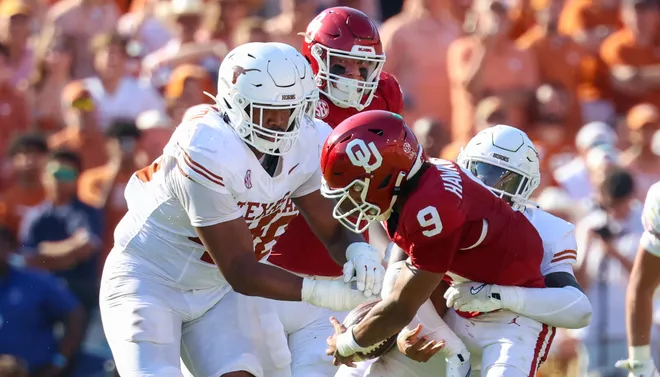 Oct 12, 2024; Dallas, Texas, USA; Texas Longhorns linebacker Anthony Hill Jr. (0) causes Oklahoma Sooners quarterback Michael Hawkins Jr. (9) to fumble during the first half at the Cotton Bowl. Mandatory Credit: Kevin Jairaj-Imagn Images