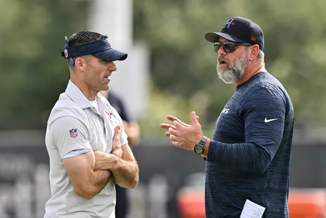 Jun 10, 2025; Houston, TX, USA; Houston Texans executive vice president and general manager Nick Caserio, left, speaks with defensive coordinator Matt Burke, right, during an NFL football minicamp at NRG Stadium. Mandatory Credit: Maria Lysaker-Imagn Images