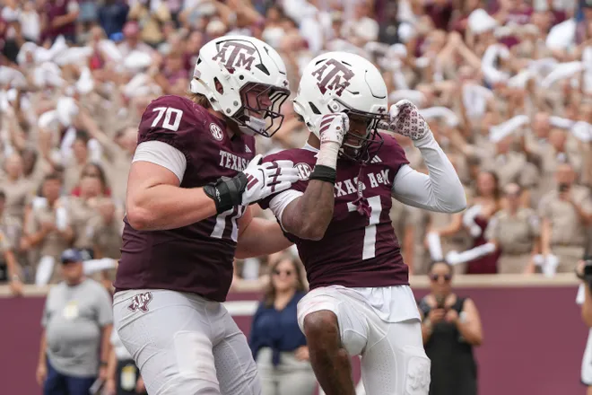 Sep 6, 2025; College Station, Texas, USA; Texas A&M Aggies offensive lineman Robert Bourdon (70) and wide receiver KC Concepcion (7) celebrate after a touchdown during the second half against the Utah State Aggies at Kyle Field. Mandatory Credit: Sean Thomas-Imagn Images