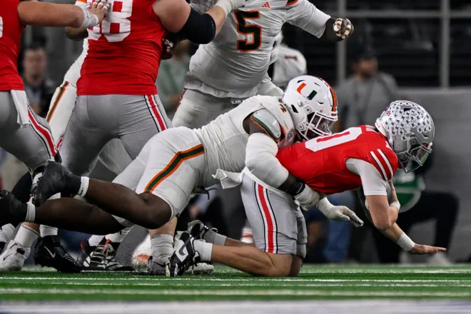 Dec 31, 2025; Arlington, TX, USA; Miami Hurricanes defensive lineman Rueben Bain Jr. (4) sacks Ohio State Buckeyes quarterback Julian Sayin (10) during the 2025 Cotton Bowl and quarterfinal game of the College Football Playoff at AT&T Stadium. Mandatory Credit: Jerome Miron-Imagn Images