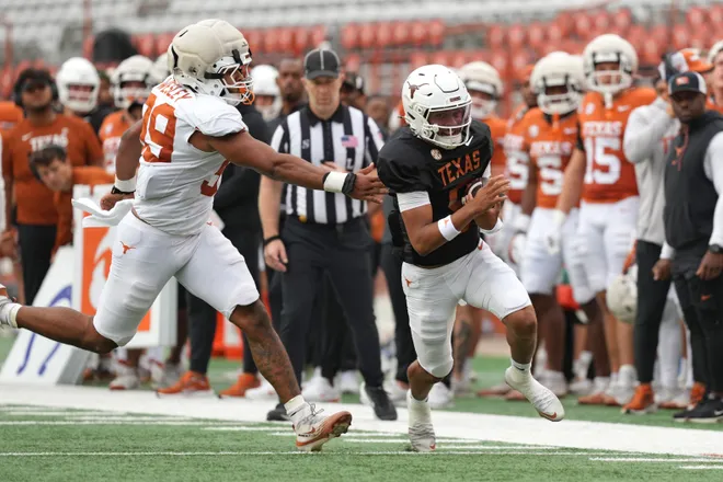 AUSTIN, TEXAS - APRIL 18: KJ Lacey Jr. #9 of the Texas Longhorns runs for yardage past Richard Wesley #99 during the Texas Spring Football Game at Darrell K Royal-Texas Memorial Stadium on April 18, 2026 in Austin, Texas. (Photo by Scott Wachter/Getty Images for ONIT)