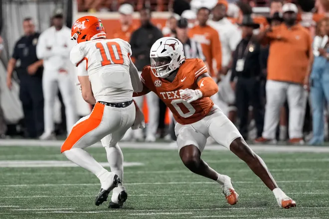 Sep 20, 2025; Austin, Texas, USA; Texas Longhorns linebacker Anthony Hill Jr (0) tackles Sam Houston Bearkats quarterback Grant Gunnell (10) during the second half at Darrell K Royal-Texas Memorial Stadium. Mandatory Credit: Scott Wachter-Imagn Images
